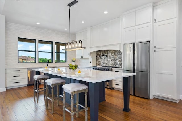 kitchen with white cabinetry, appliances with stainless steel finishes, and a kitchen island