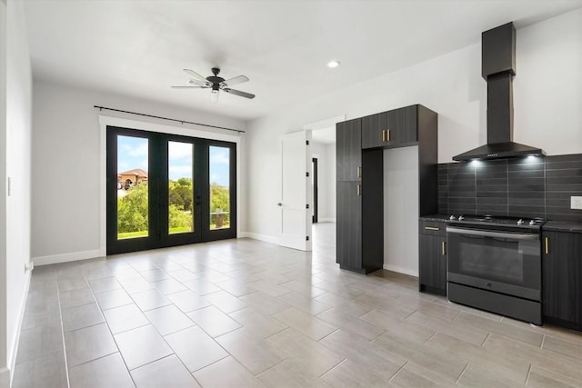 kitchen featuring ceiling fan, backsplash, island exhaust hood, stainless steel electric stove, and french doors