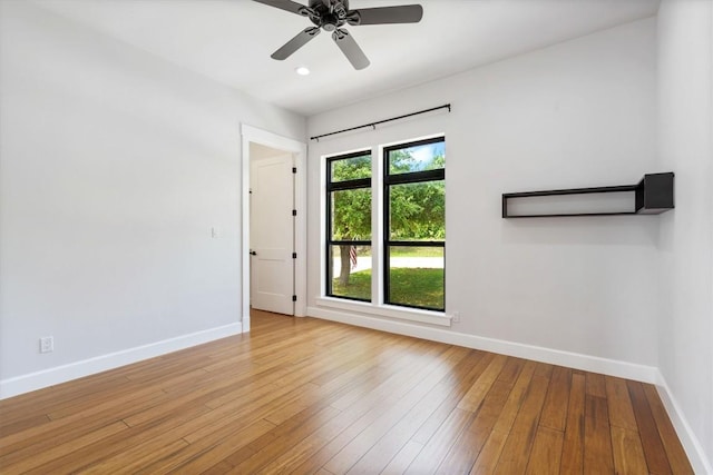 empty room with light hardwood / wood-style flooring and ceiling fan