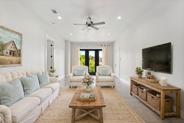 tiled living room featuring french doors and ceiling fan