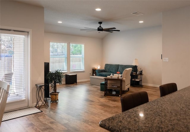 living room featuring hardwood / wood-style flooring, lofted ceiling, and ceiling fan