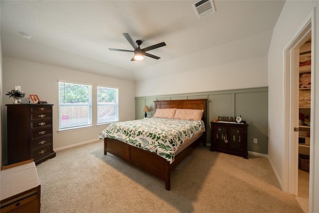 carpeted bedroom with ceiling fan and lofted ceiling