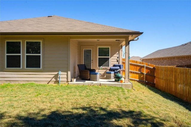 back of property featuring a lawn and a patio area