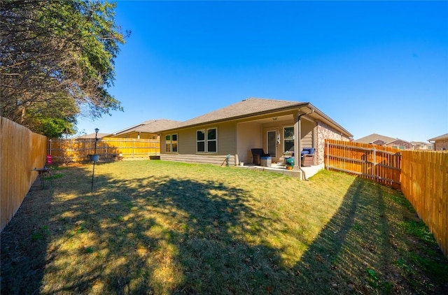 rear view of property featuring a yard