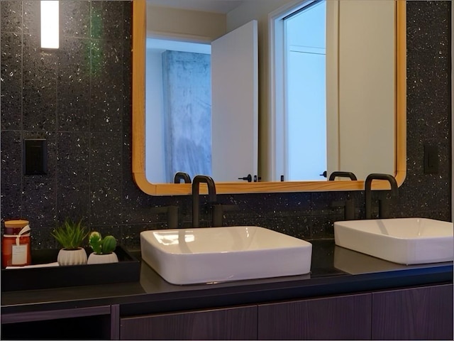 bathroom with vanity and decorative backsplash