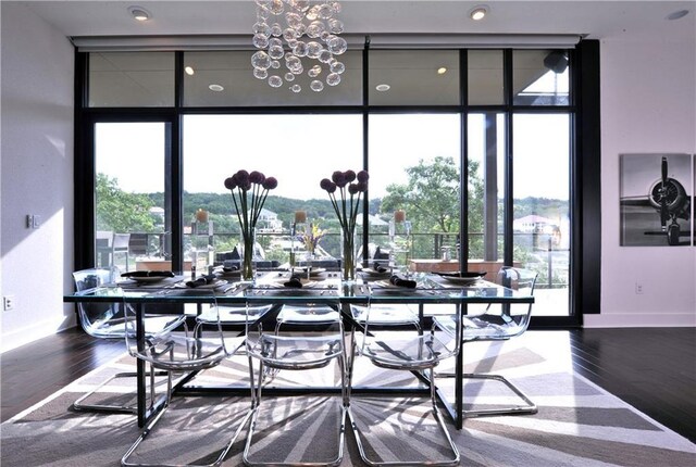 dining room featuring hardwood / wood-style flooring, a wall of windows, and a notable chandelier