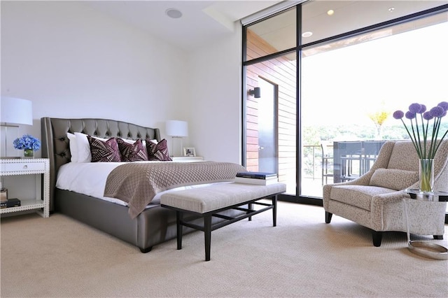 bedroom with light carpet, access to exterior, and floor to ceiling windows