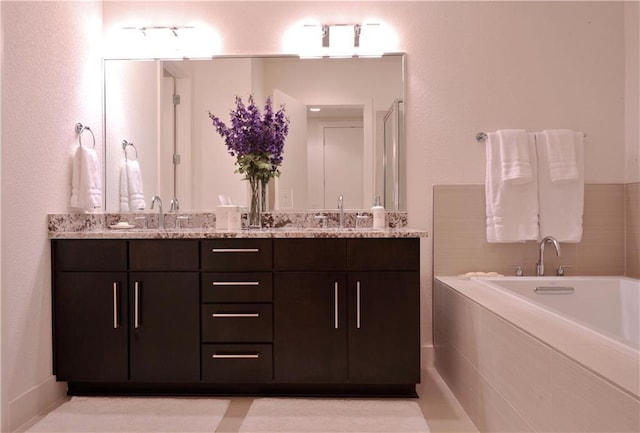 bathroom featuring vanity and a bath