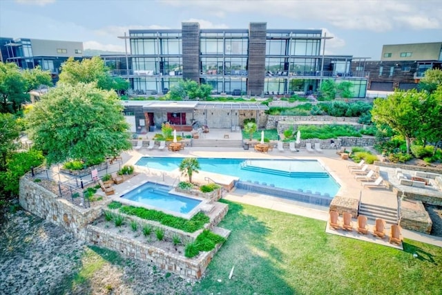 view of swimming pool with a community hot tub and a patio area