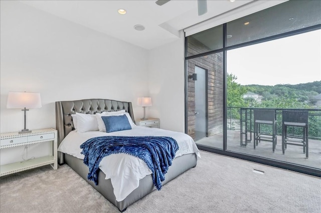 carpeted bedroom with access to exterior and expansive windows