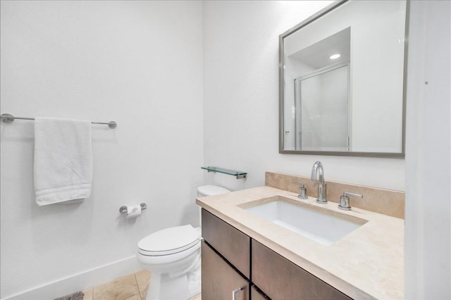 bathroom with tile patterned flooring, vanity, a shower with shower door, and toilet