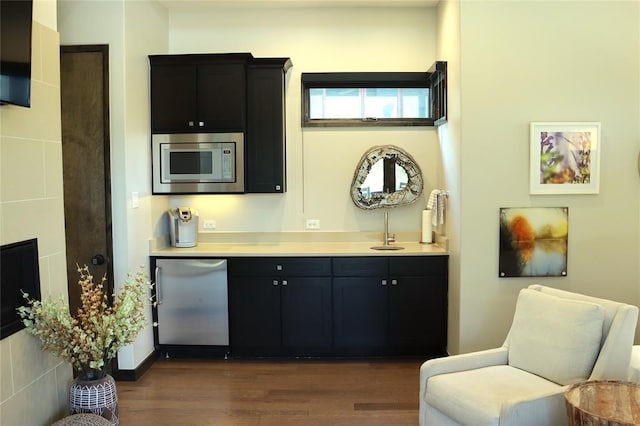 kitchen featuring fridge, stainless steel microwave, and dark hardwood / wood-style flooring