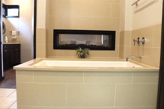 bathroom with vanity and a bathtub