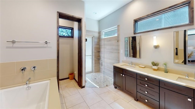 bathroom featuring tile patterned flooring, vanity, and separate shower and tub