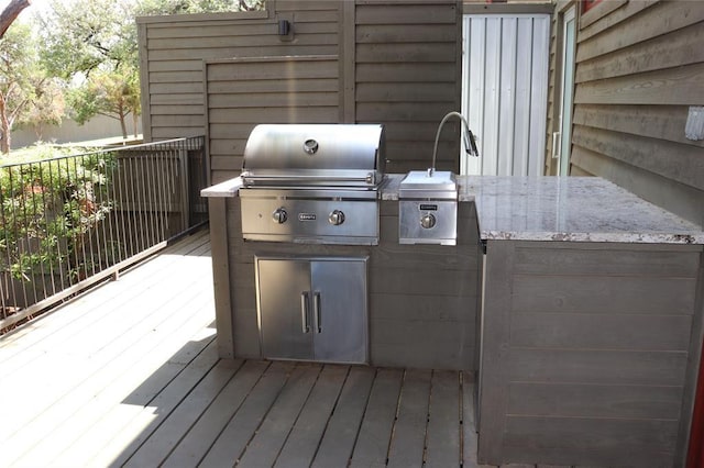 wooden terrace with area for grilling and a grill