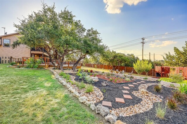 3709 Alamo Cv, Lago Vista, TX 78645 - view of yard featuring a vegetable garden and a deck