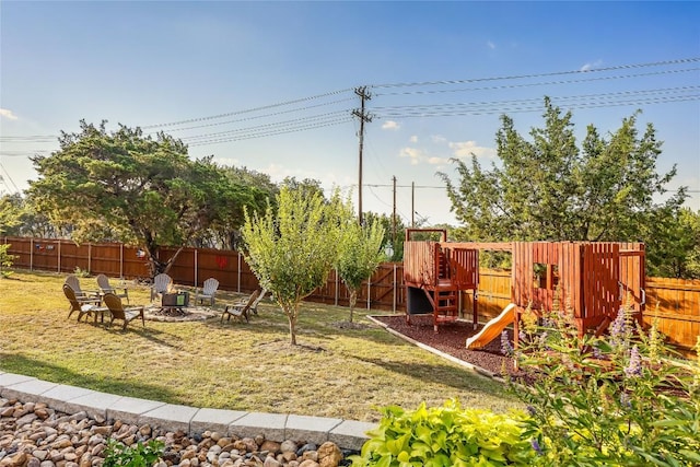 view of yard featuring a playground and a fire pit