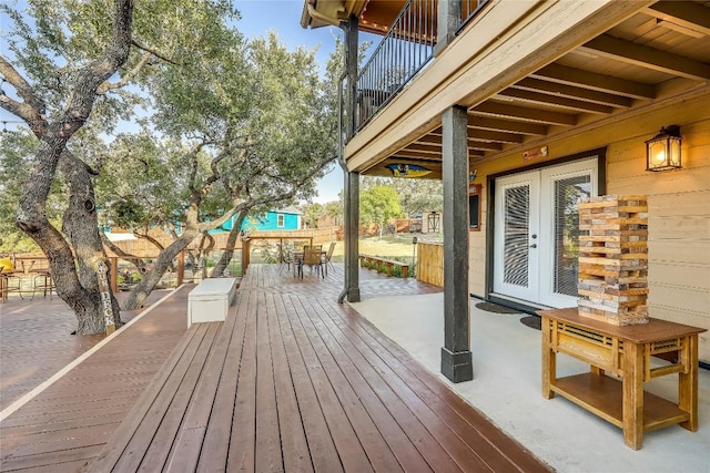 3709 Alamo Cv, Lago Vista, TX 78645 - wooden terrace with french doors and outdoor dining space