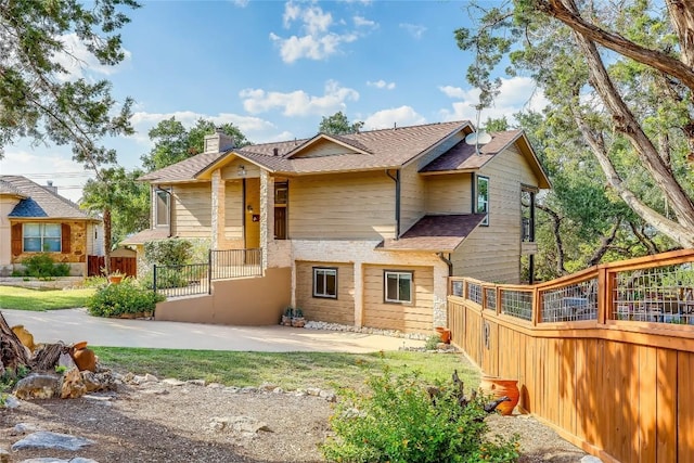 3709 Alamo Cv, Lago Vista, TX 78645 - view of front of property with a chimney and a shingled roof