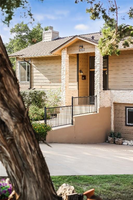 3709 Alamo Cv, Lago Vista, TX 78645 - entrance to property featuring a chimney and covered porch