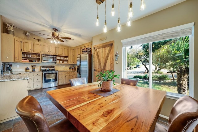 dining room featuring ceiling fan and sink