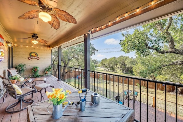 wooden deck featuring ceiling fan