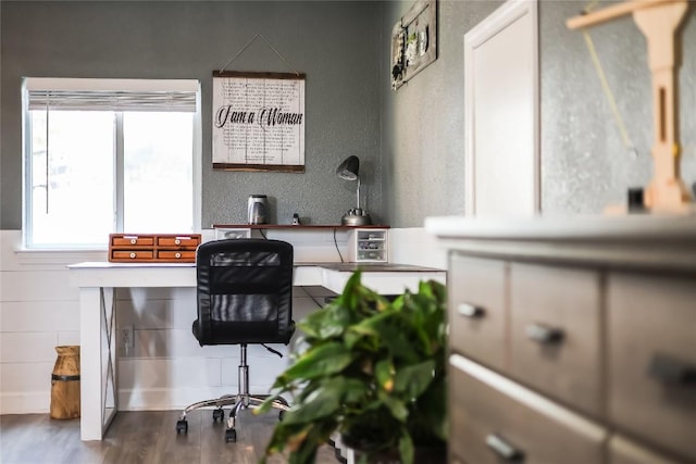 bar with hardwood / wood-style floors and white cabinets