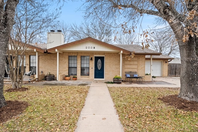 view of front of home with a garage, a porch, and a front lawn