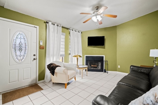 tiled living room featuring ceiling fan