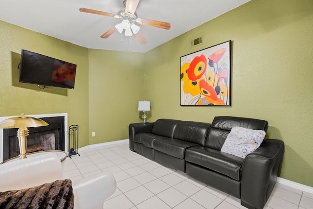 tiled living room featuring ceiling fan