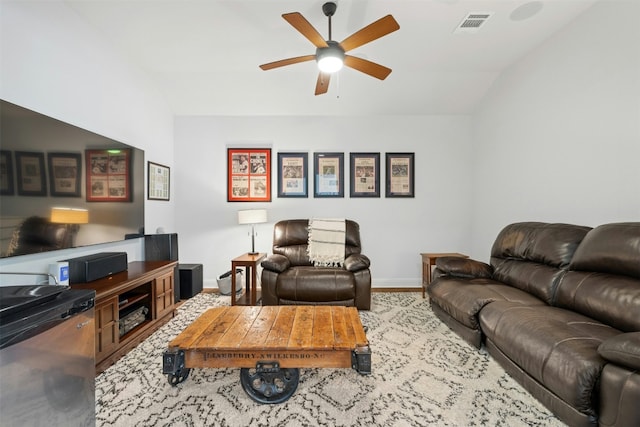 living room featuring hardwood / wood-style flooring, ceiling fan, and vaulted ceiling