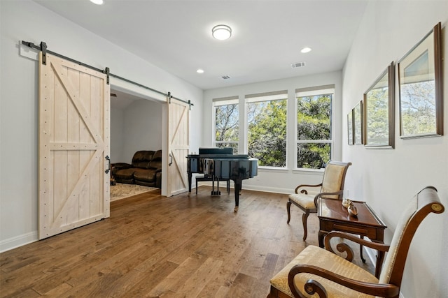 living area with hardwood / wood-style floors and a barn door