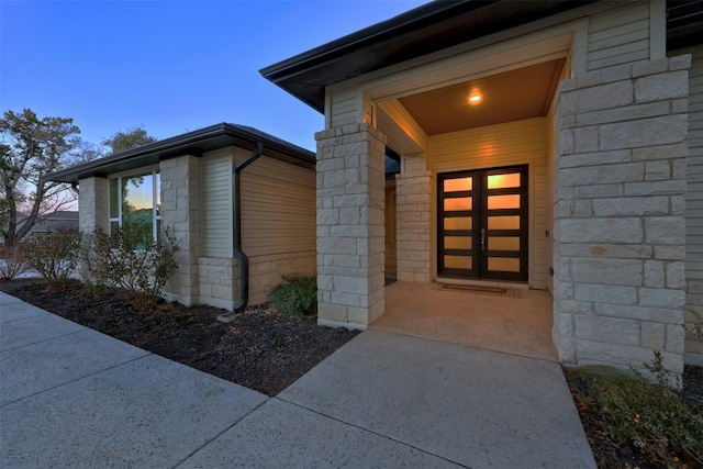 view of exterior entry at dusk