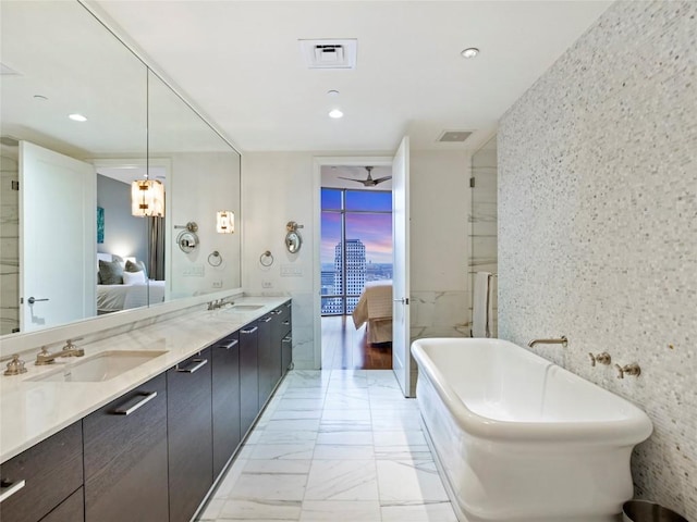 bathroom with vanity, a bathing tub, and ceiling fan