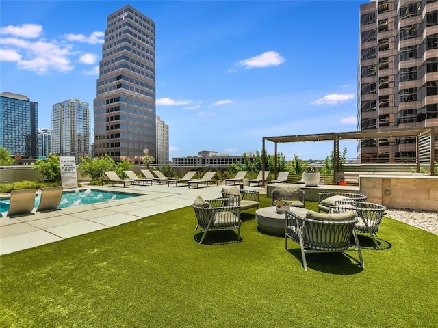 view of community with a patio, a swimming pool, and a yard