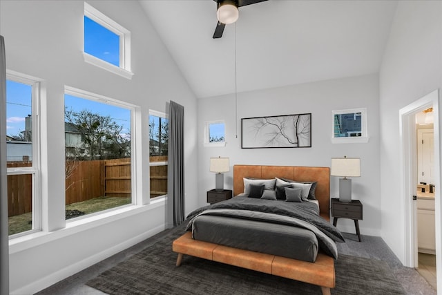 carpeted bedroom featuring baseboards, high vaulted ceiling, and a ceiling fan