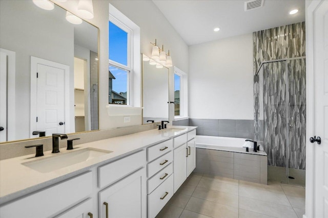 bathroom featuring a sink, visible vents, tiled shower, a bath, and tile patterned floors