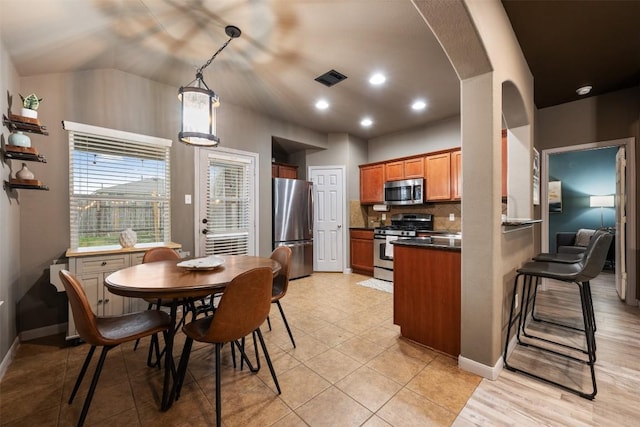 tiled dining area with lofted ceiling