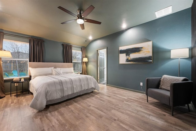 bedroom with lofted ceiling, ceiling fan, and light hardwood / wood-style flooring