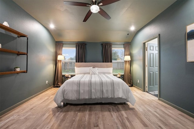 bedroom featuring ceiling fan, lofted ceiling, and light hardwood / wood-style floors