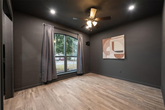 unfurnished room featuring ceiling fan and light wood-type flooring