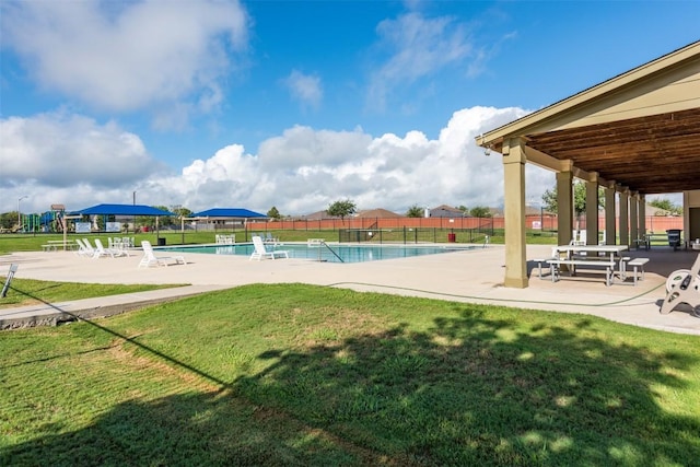 view of swimming pool featuring a patio area and a lawn