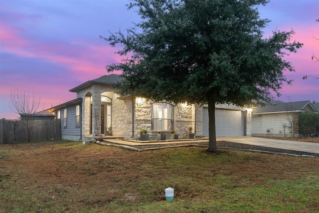 view of front facade featuring a garage and a lawn