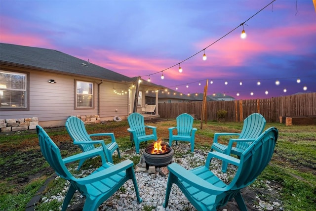 patio terrace at dusk featuring an outdoor fire pit