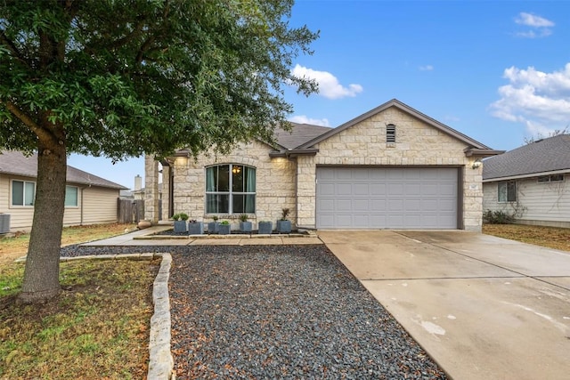 view of front of home featuring cooling unit and a garage