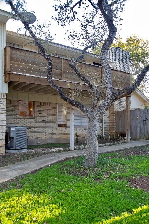 view of home's exterior with central AC and a lawn