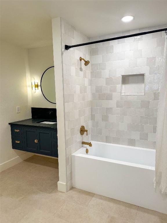 bathroom featuring vanity, tile patterned floors, and shower / bath combo with shower curtain