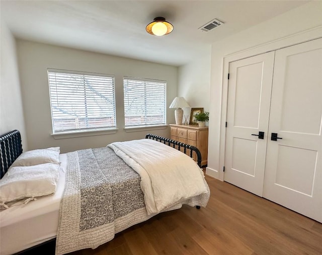 bedroom featuring hardwood / wood-style floors and a closet