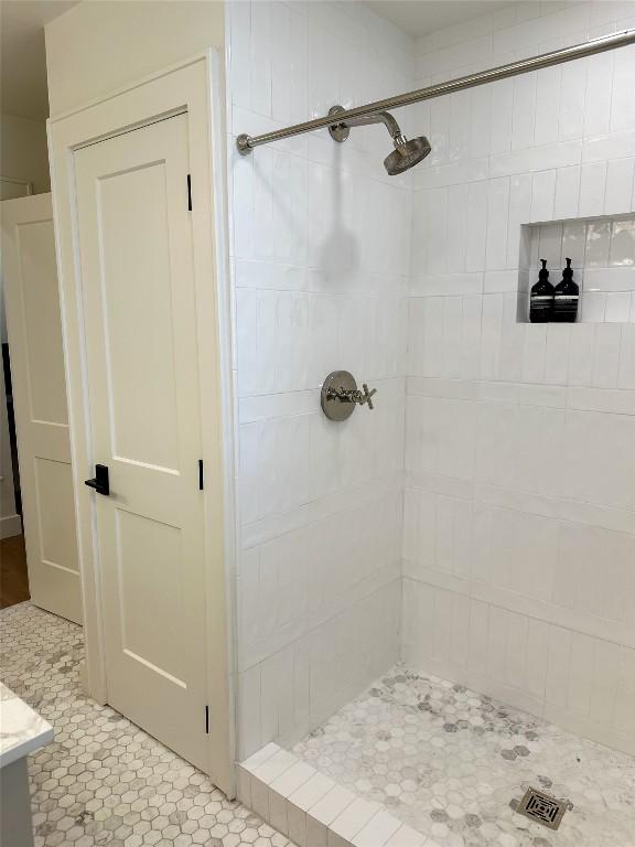 bathroom featuring vanity and a tile shower