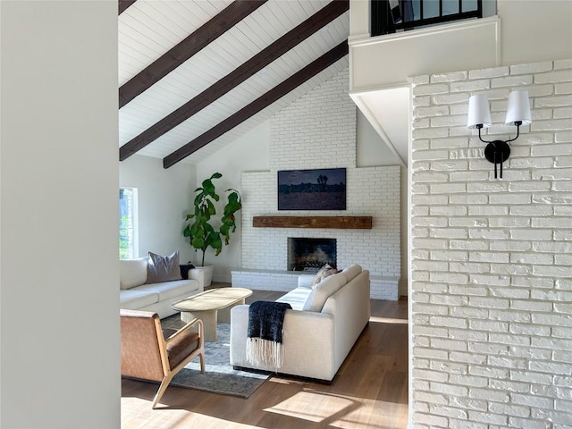 living room with a brick fireplace, wood-type flooring, high vaulted ceiling, and beamed ceiling